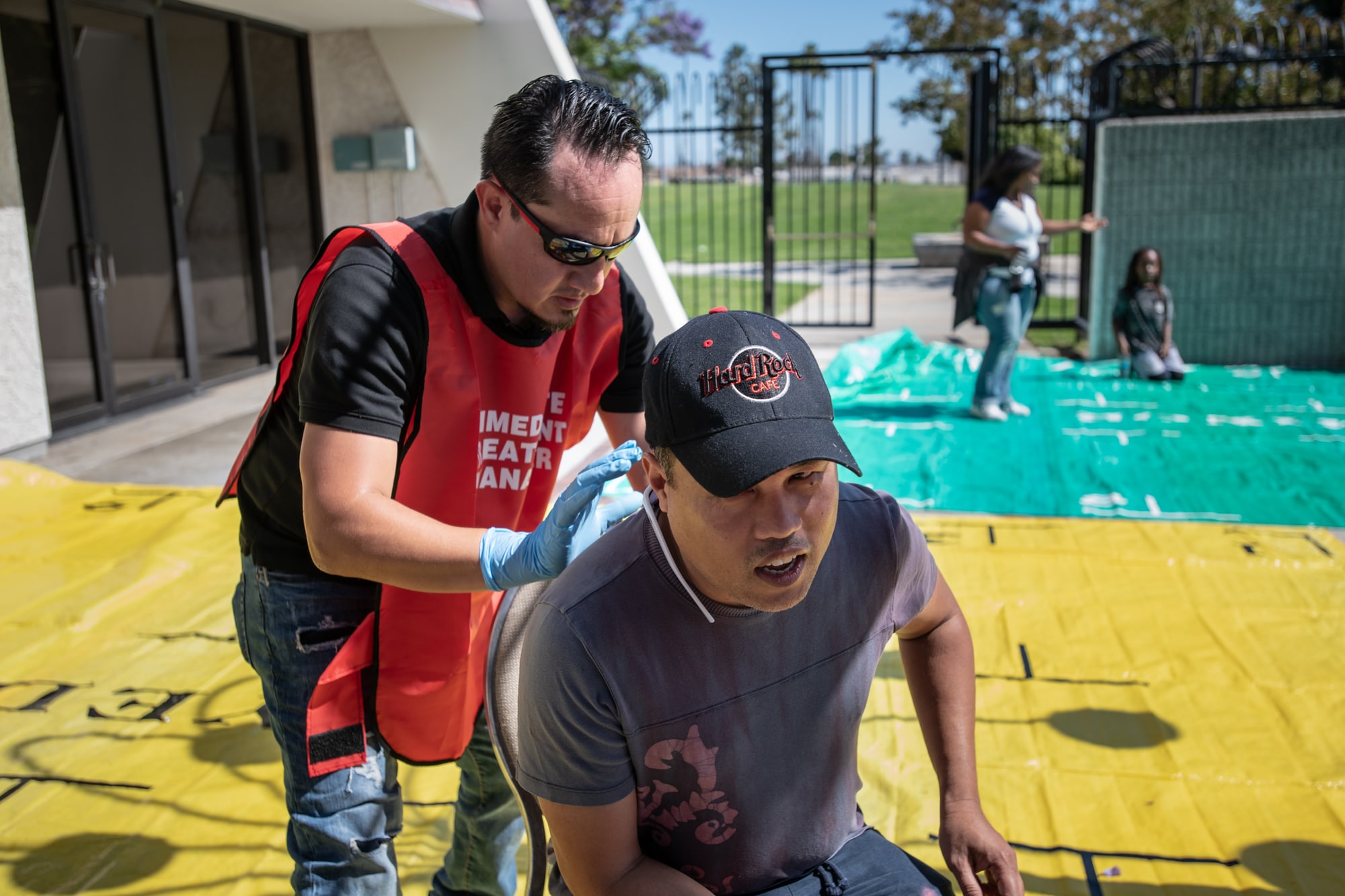 Ricardo Martinez (left) treats Derrick Kim for a simulated injury during  disaster training for their Community Emergency Response Team in Carson, California. (Brigette Waltermire/News21)