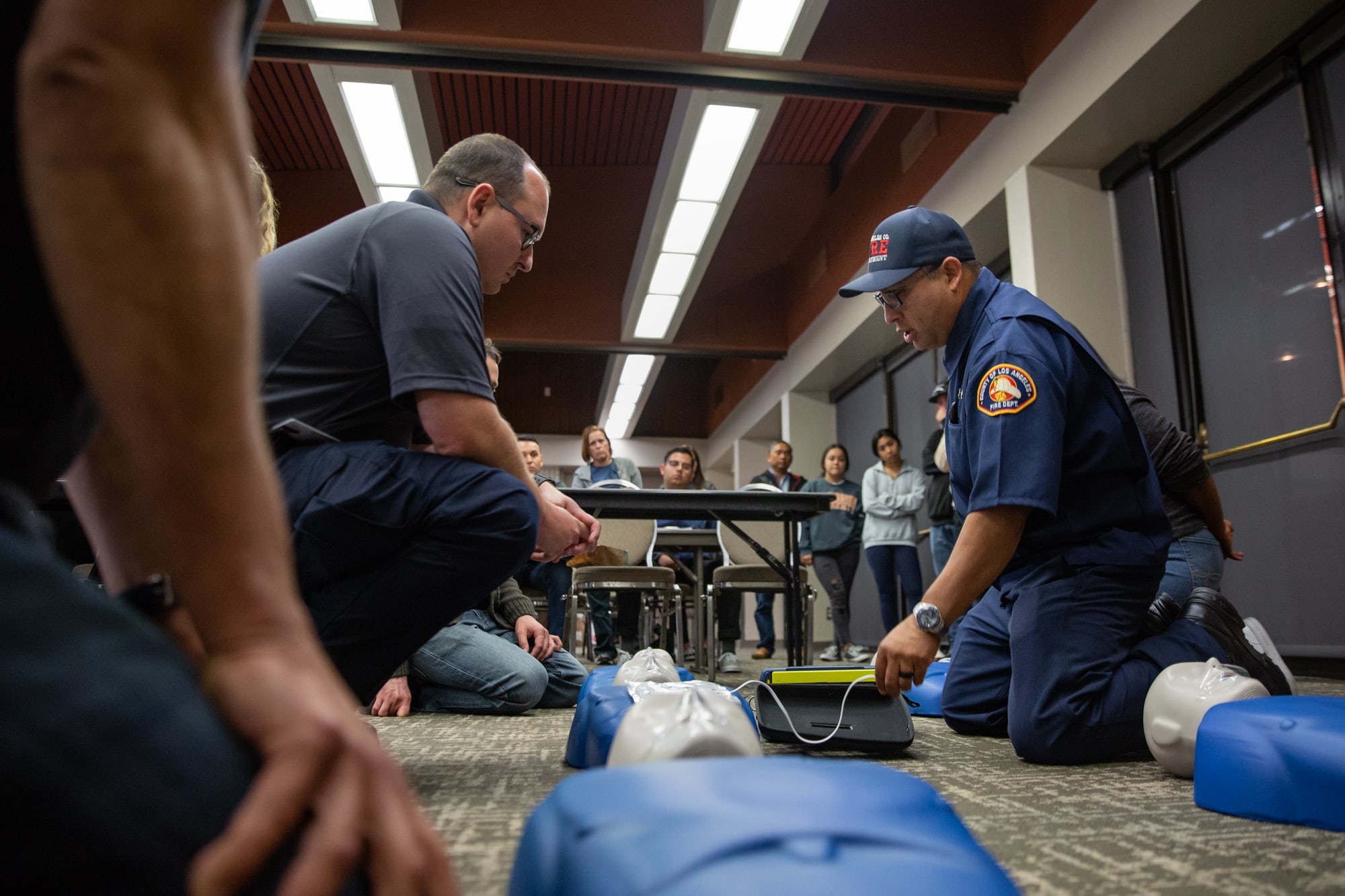 Luis Gonzalez, a Community Emergency Response Team instructor from the Los Angeles County Fire Department, showed trainees how to attach an automated external defibrillator during a CPR demonstration in Carson, California. (Brigette Waltermire/News21)