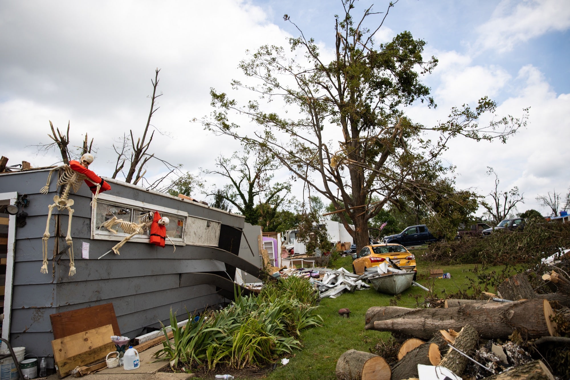 Plastic skeletons with life vests around their necks hang from a house whose roof was ripped off by a tornado that ping-ponged through the Dayton, Ohio, area in May. (Stacy Fernández/News21)